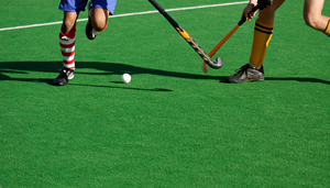 Two people playing hockey